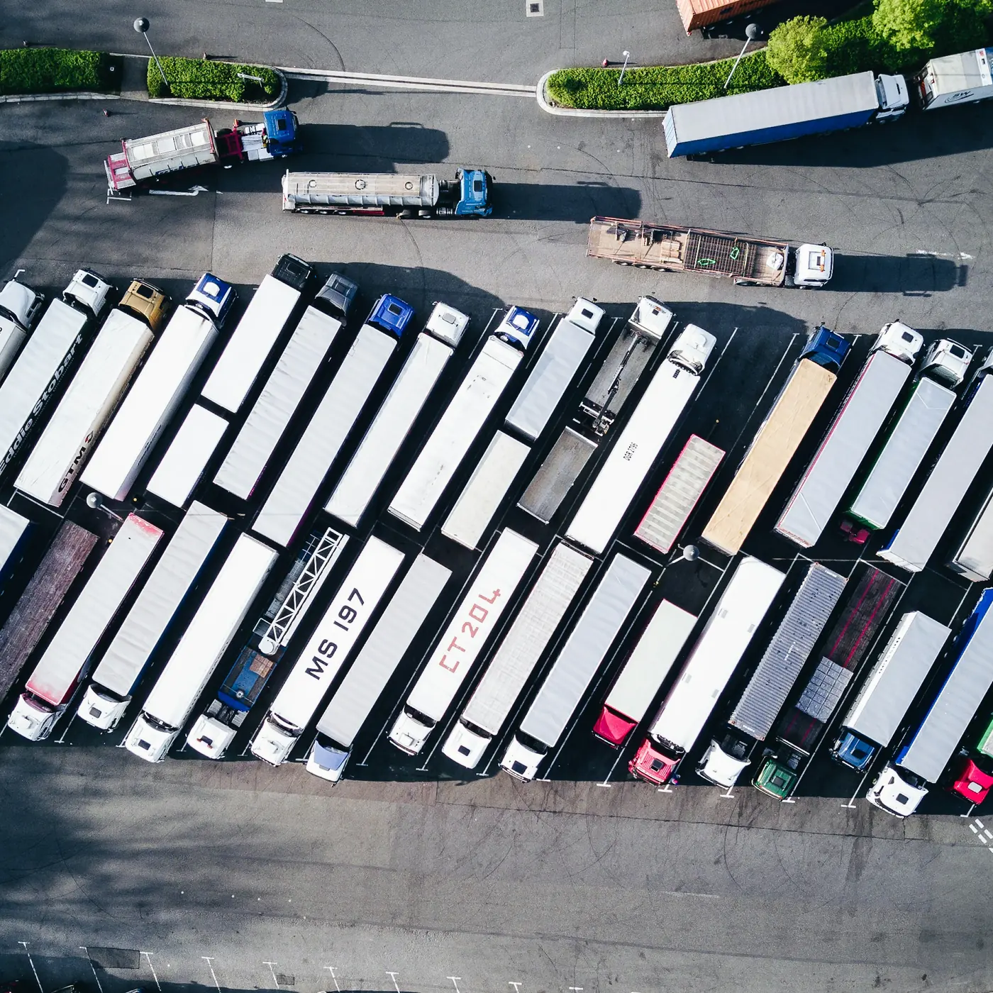 Aerial view of a freight yard with dozens of trucks