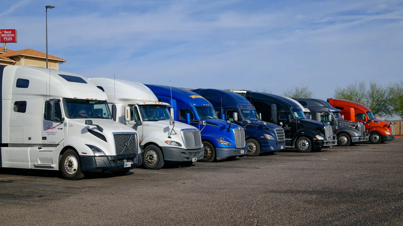 Trucks from different carriers, in different colors, parked in a row
